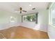 Sunlit living room with hardwood floors and large window view to the outside at 8375 Sw 109Th Lane Rd, Ocala, FL 34481