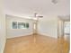 Bright living room with hardwood floors, ceiling fan, large window, and view of entryway at 8375 Sw 109Th Lane Rd, Ocala, FL 34481