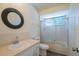 Well-lit bathroom featuring a vanity with a modern round mirror and a shower with glass doors at 8463 Sw 108Th Pl, Ocala, FL 34481