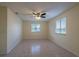 Bright bedroom with tile floors and a ceiling fan at 8463 Sw 108Th Pl, Ocala, FL 34481