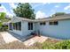 Charming exterior view of the home with light blue siding and a sunroom at 8463 Sw 108Th Pl, Ocala, FL 34481