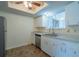 Clean kitchen with white cabinetry, stainless steel appliances, and stylish vinyl flooring at 8463 Sw 108Th Pl, Ocala, FL 34481