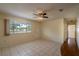 Bright, airy living room with tile flooring, neutral walls, a fan, and a large window at 8463 Sw 108Th Pl, Ocala, FL 34481