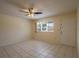 Bright living room with neutral paint, tile floors, ceiling fan, and natural light at 8463 Sw 108Th Pl, Ocala, FL 34481