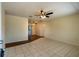 Spacious living area featuring tile flooring, a ceiling fan, and a hallway to other rooms at 8463 Sw 108Th Pl, Ocala, FL 34481