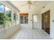 Inviting sunroom features tile floors, a ceiling fan, and access to the outdoors at 8463 Sw 108Th Pl, Ocala, FL 34481