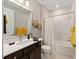 Bathroom with a large mirror over a sink with a white countertop and a shower/tub with a curtain at 8820 Sw 58Th Street Rd, Ocala, FL 34481