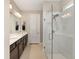 Bathroom featuring a glass enclosed shower and a double sink vanity with a dark wood finish at 8820 Sw 58Th Street Rd, Ocala, FL 34481