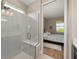 Tiled walk-in shower with a built-in bench and a view of the bedroom through an open doorway at 8820 Sw 58Th Street Rd, Ocala, FL 34481