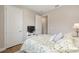 Bedroom featuring a TV on a white console and views into an adjacent hallway at 8820 Sw 58Th Street Rd, Ocala, FL 34481