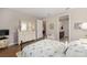 Bedroom with a bed, hardwood floors, and a dresser, connecting to a hallway and bathroom at 8820 Sw 58Th Street Rd, Ocala, FL 34481