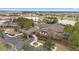 Aerial view of large clubhouse featuring porte cochere and lakeside pool at 8820 Sw 58Th Street Rd, Ocala, FL 34481