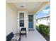 Cozy front porch with seating, a decorated blue front door, and tasteful landscaping at 8820 Sw 58Th Street Rd, Ocala, FL 34481