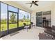 Screened lanai features a ceiling fan, outdoor furniture, and sliding glass doors to the kitchen at 8820 Sw 58Th Street Rd, Ocala, FL 34481