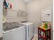 Laundry room with a front load washer and dryer, shelving and storage solutions at 8820 Sw 58Th Street Rd, Ocala, FL 34481