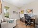 Home office featuring a comfortable sofa, a large desk and a view of the yard at 8820 Sw 58Th Street Rd, Ocala, FL 34481