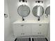 Bright bathroom featuring double sinks, black fixtures, and modern lighting at 9029 Se 135Th Loop, Summerfield, FL 34491