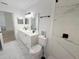 Bright bathroom with a double sink vanity, toilet, and tile flooring and backsplash at 9029 Se 135Th Loop, Summerfield, FL 34491