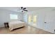 Bright bedroom with light wood floors, french doors, and window at 9029 Se 135Th Loop, Summerfield, FL 34491