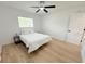 Bright bedroom featuring wood floors, ceiling fan, and white walls at 9029 Se 135Th Loop, Summerfield, FL 34491