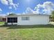 Image showcasing the side of the house, highlighting the lawn and windows at 9029 Se 135Th Loop, Summerfield, FL 34491