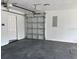 Clean and spacious garage with a grey epoxy floor and a white garage door at 9029 Se 135Th Loop, Summerfield, FL 34491