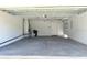 Spacious garage with epoxy floor, perfect for parking and storage at 9029 Se 135Th Loop, Summerfield, FL 34491