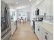 Bright, open kitchen features stainless steel appliances and white cabinets, perfect for cooking and entertaining at 9029 Se 135Th Loop, Summerfield, FL 34491