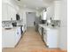 Beautiful kitchen boasts white cabinets, stainless steel appliances, and modern backsplash at 9029 Se 135Th Loop, Summerfield, FL 34491