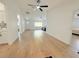 Spacious living area featuring wood flooring, white walls, and abundant natural light at 9029 Se 135Th Loop, Summerfield, FL 34491
