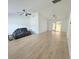 Bright living room with high ceilings, ceiling fans, and stylish gray couch with a blanket at 9029 Se 135Th Loop, Summerfield, FL 34491
