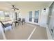 Relaxing sunroom featuring a ceiling fan, neutral paint, and comfortable seating for relaxing and reading at 9029 Se 135Th Loop, Summerfield, FL 34491