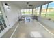 Relaxing sunroom with plenty of natural light and comfortable seating arrangement at 9029 Se 135Th Loop, Summerfield, FL 34491