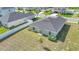 Backyard view of the home showing the well-kept lawn and simple, minimal landscaping at 9266 Sw 58Th Cir, Ocala, FL 34476