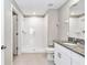 Bathroom featuring a walk-in shower with tiled walls, plus a granite-topped vanity at 9266 Sw 58Th Cir, Ocala, FL 34476