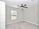 Cozy bedroom featuring neutral walls, carpet flooring, a ceiling fan, and a bright window offering natural light at 9266 Sw 58Th Cir, Ocala, FL 34476