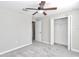 Spacious bedroom with neutral walls, carpet, a ceiling fan, and a closet, offering comfort and functionality at 9266 Sw 58Th Cir, Ocala, FL 34476