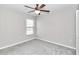 Empty bedroom has neutral walls, carpet, a window and ceiling fan with light at 9266 Sw 58Th Cir, Ocala, FL 34476