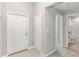 Inviting entryway showcasing neutral paint, a closet, and tile flooring transitioning into carpet, leading to other rooms at 9266 Sw 58Th Cir, Ocala, FL 34476