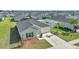 Single-story home featuring a two-car garage, a well-kept lawn, and minimal landscaping at 9266 Sw 58Th Cir, Ocala, FL 34476