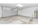 Spacious garage with high ceilings, a roll-up door, and ample room for storage at 9266 Sw 58Th Cir, Ocala, FL 34476