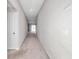 Bright hallway featuring neutral walls, plush carpeting, and open view towards a sliding glass door inviting natural light at 9266 Sw 58Th Cir, Ocala, FL 34476