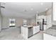 Open floor plan features kitchen island with granite counters, stainless appliances, and living room at 9266 Sw 58Th Cir, Ocala, FL 34476