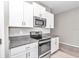 Granite counters and stainless-steel oven and microwave add modern luxury to this kitchen at 9266 Sw 58Th Cir, Ocala, FL 34476