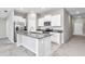 Charming kitchen features an island with granite countertop and stainless steel appliances at 9266 Sw 58Th Cir, Ocala, FL 34476
