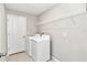 Convenient laundry room equipped with a washer, dryer, and built-in shelving at 9266 Sw 58Th Cir, Ocala, FL 34476