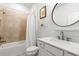Clean bathroom featuring a tub with tile surround, a white vanity, and a modern faucet at 9459 Sw 52Nd Loop, Ocala, FL 34481