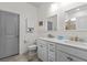 Bright bathroom featuring double sinks, modern fixtures, and a separate toilet area at 9459 Sw 52Nd Loop, Ocala, FL 34481