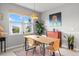 Bright dining area featuring a wooden table, stylish chairs, and natural light at 9459 Sw 52Nd Loop, Ocala, FL 34481