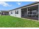 Exterior home view showcasing the screened patio with a well manicured lawn at 9459 Sw 52Nd Loop, Ocala, FL 34481
